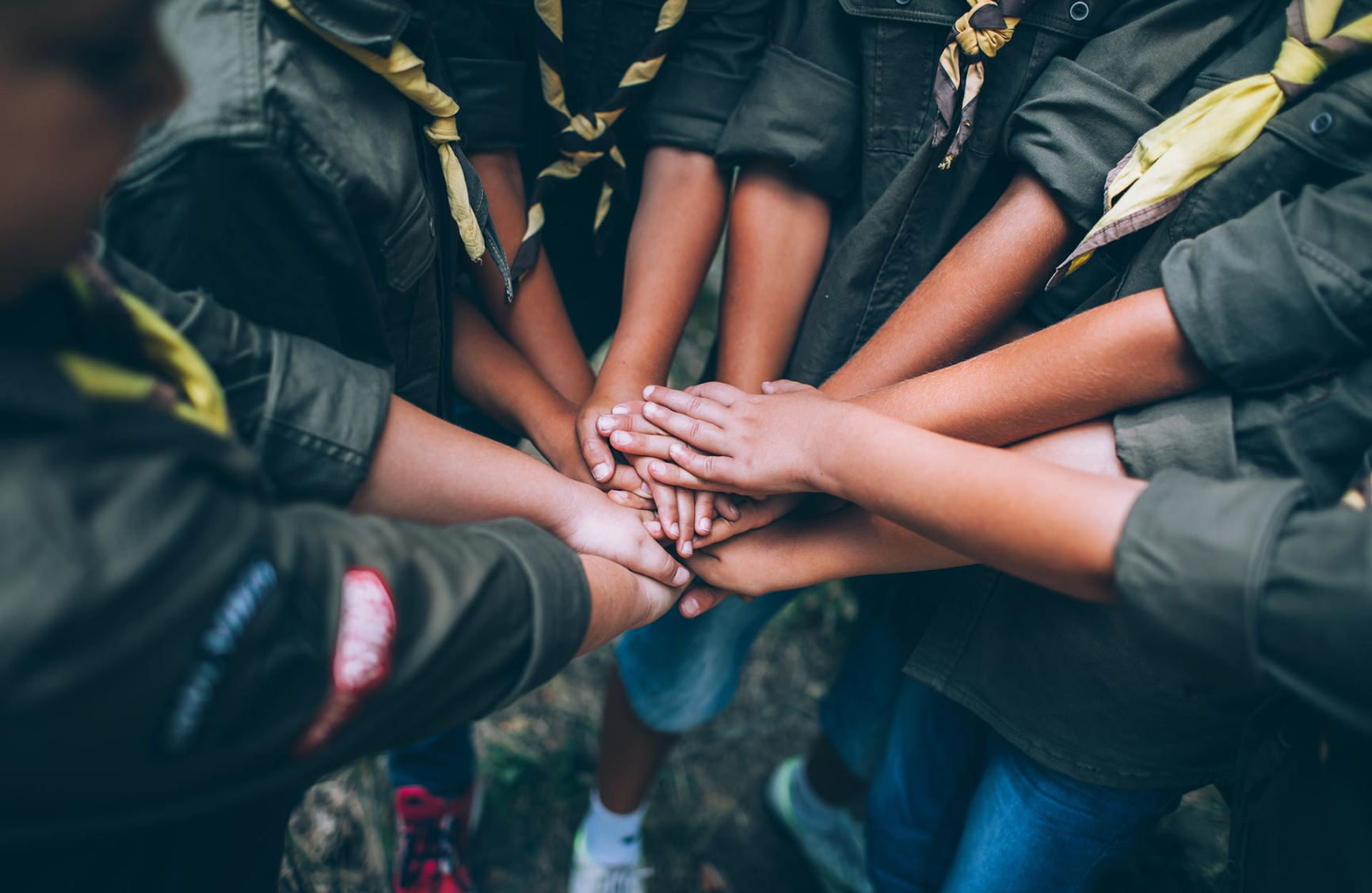 a scout troop all holding hands in the middle